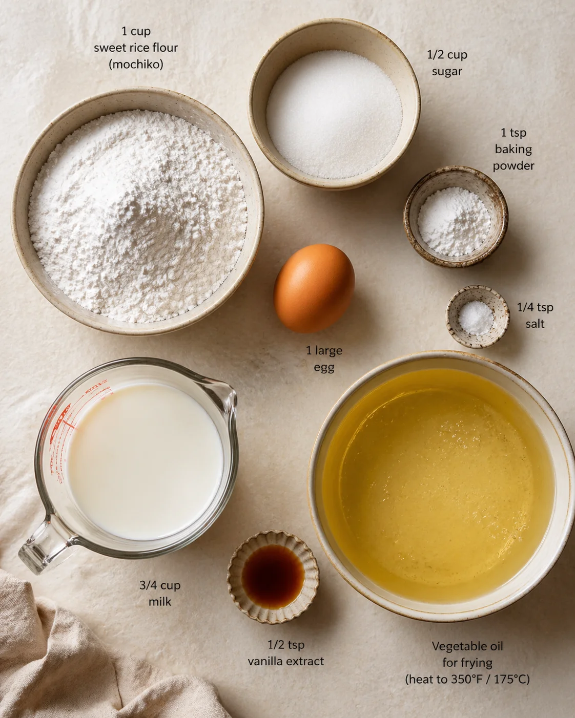 ingredients-placeholder.png Measured ingredients arranged for Mochi Doughnuts: 1 cup sweet rice flour (mochiko), 1/2 cup sugar, 1 tsp baking powder, 1/4 tsp salt, 1 large egg, 3/4 cup milk (or any milk alternative you like)