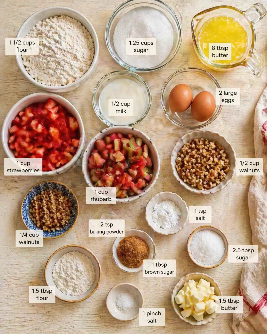 Overhead view of baking ingredients laid out in bowls with labeled measurements on a wooden surface.