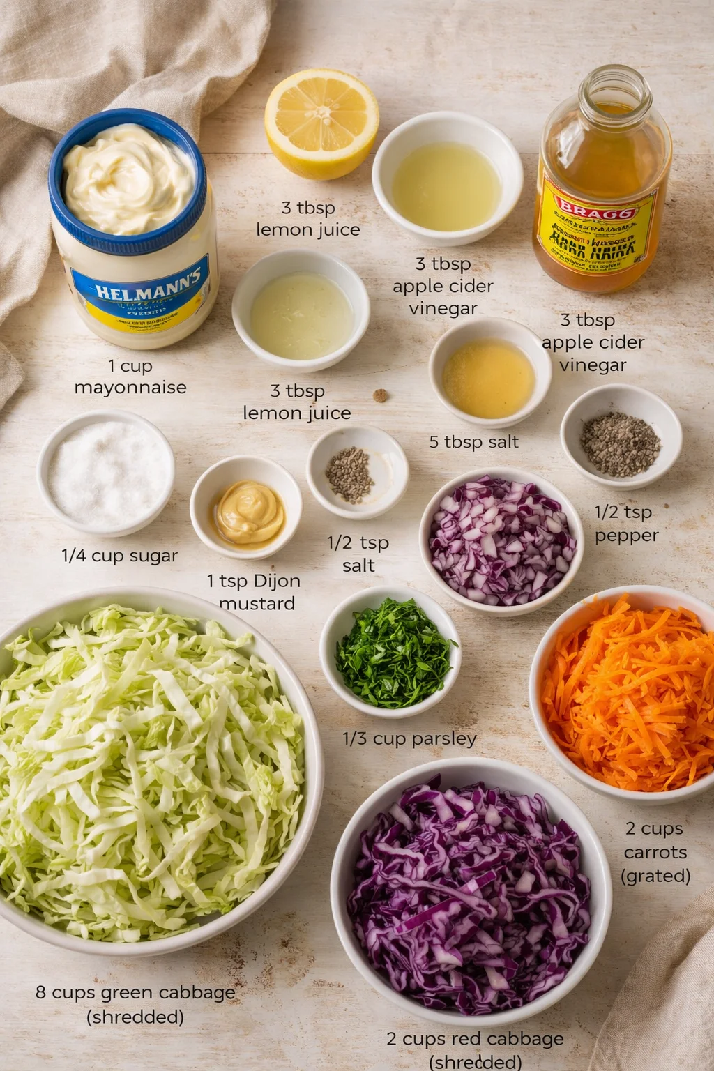 Overhead view of colorful shredded cabbage, carrots, red onion, herbs, and dressing ingredients with labels.
