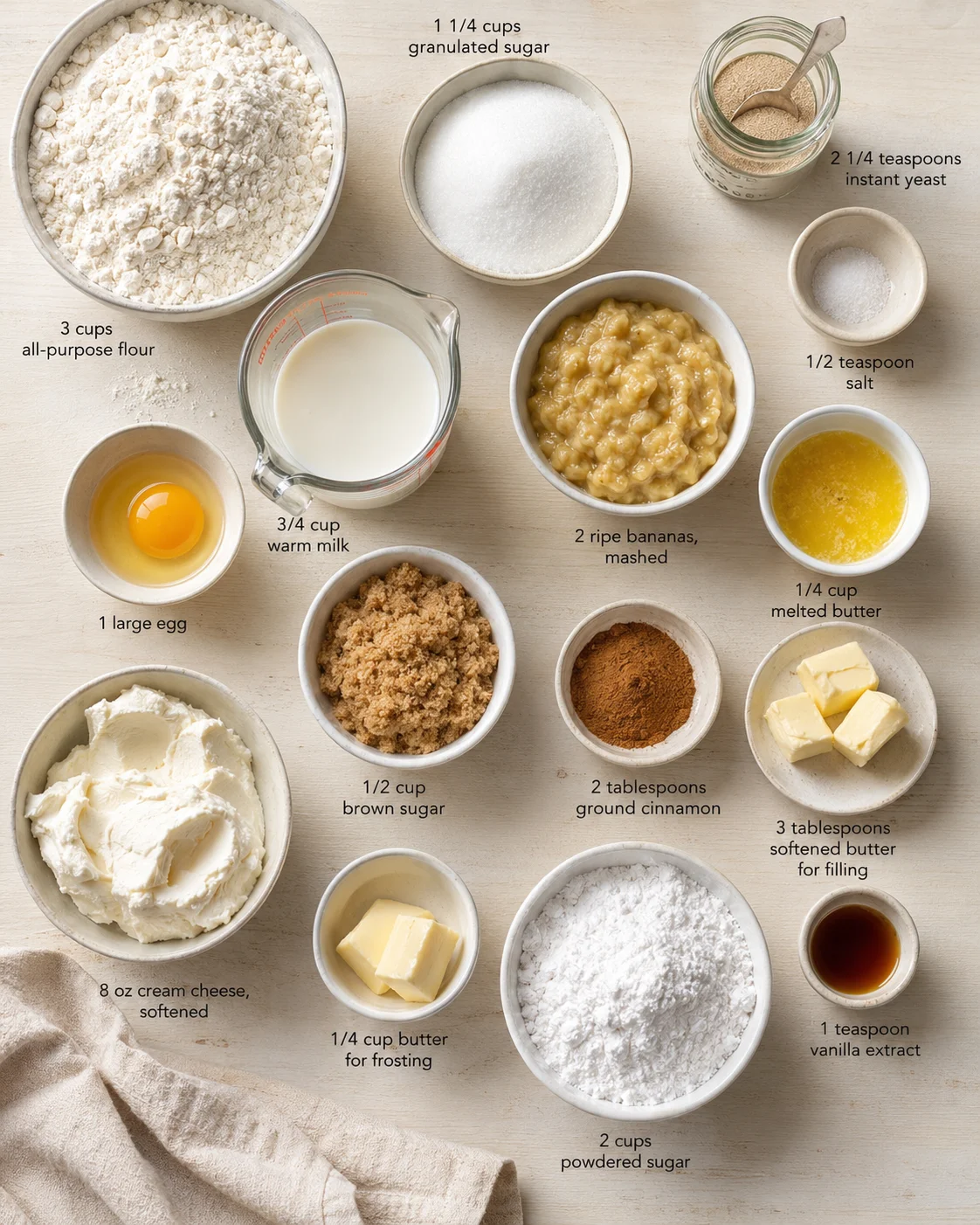 Overhead shot of banana bread ingredients arranged in bowls with labeled quantities.