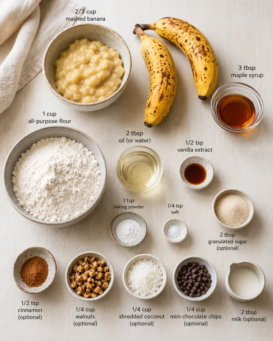 flat lay of banana bread ingredients arranged on a light wooden surface