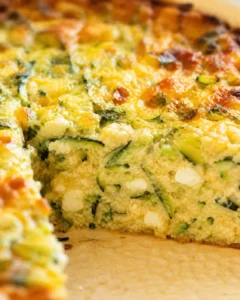 close-up of crustless veggie quiche slice with zucchini and melted cheese