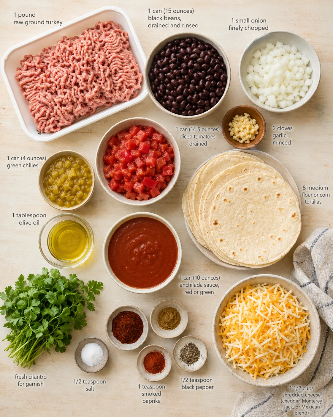 Top-down view of raw turkey, beans, veggies, tortillas, and cheese arranged for enchiladas on a light wood surface.