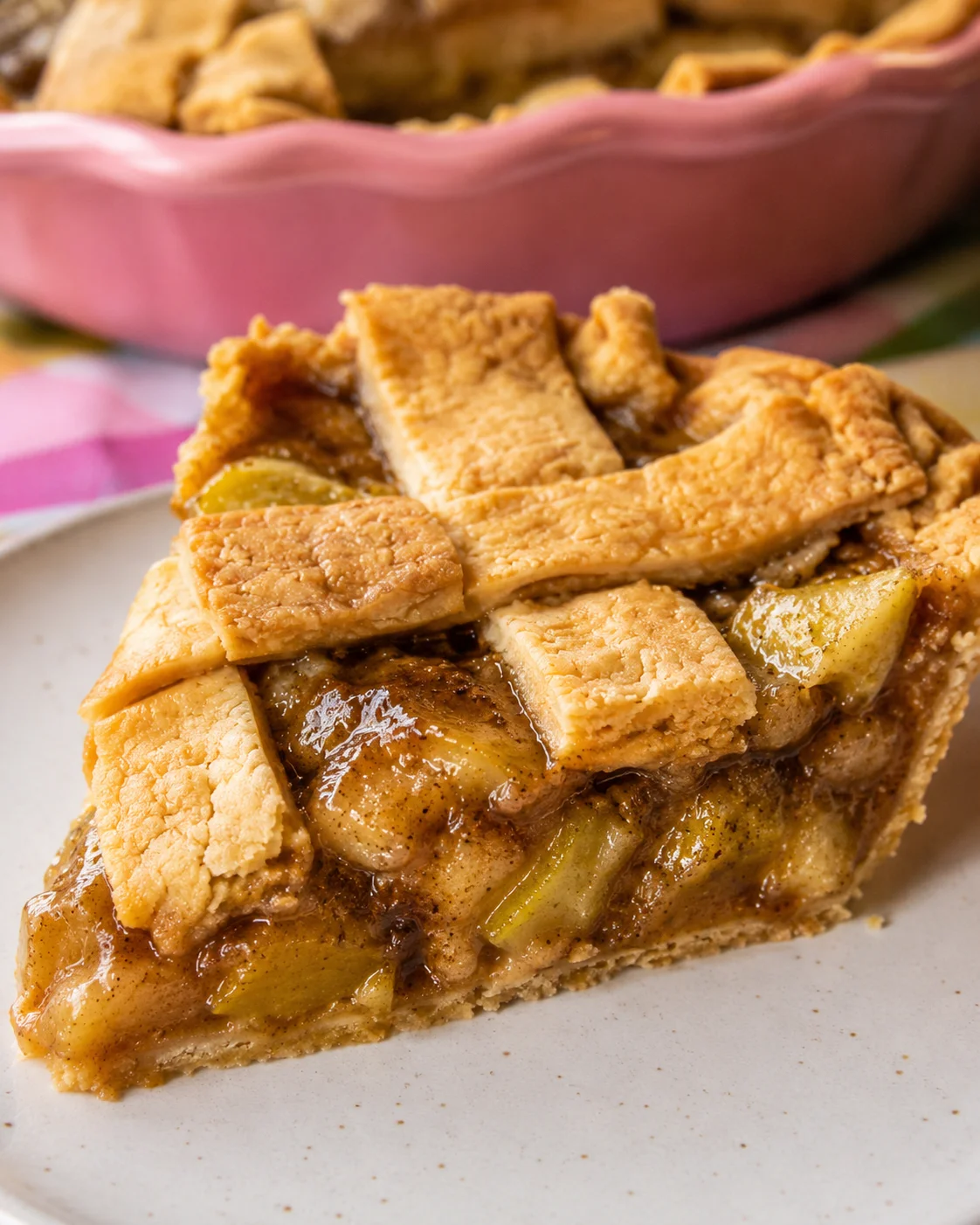 Close-up of a slice of green tomato pie with lattice crust and caramelized filling