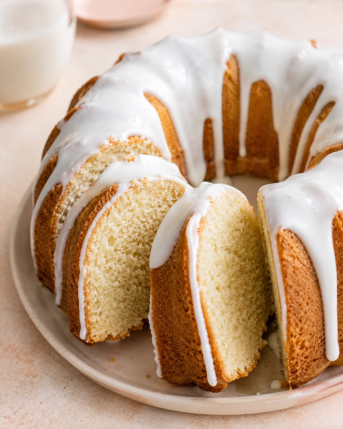 Decorative vanilla Bundt cake with white glaze on a plate