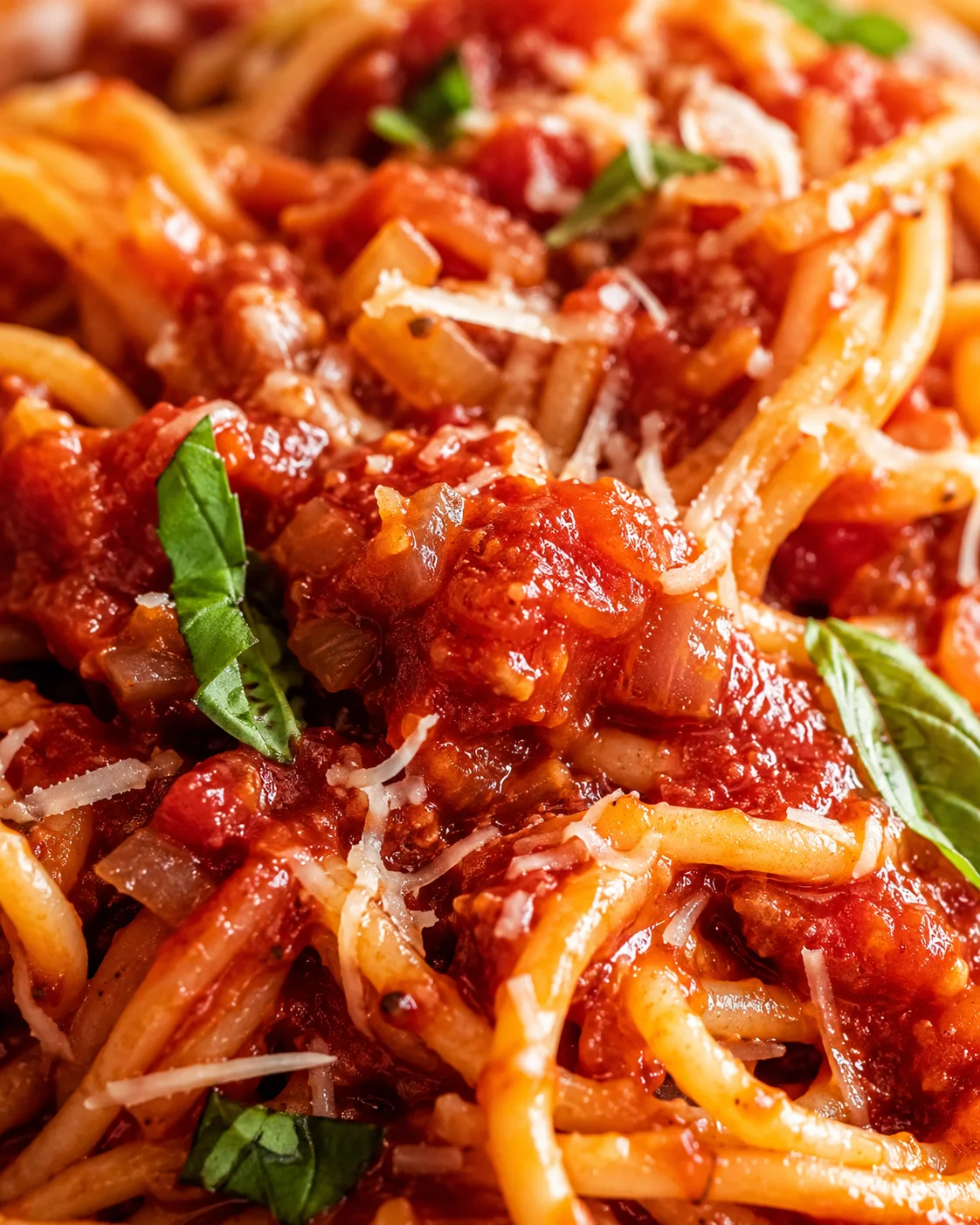 Red Wine Pasta Sauce Close-up view of spaghetti with rich red wine tomato sauce and fresh basil.