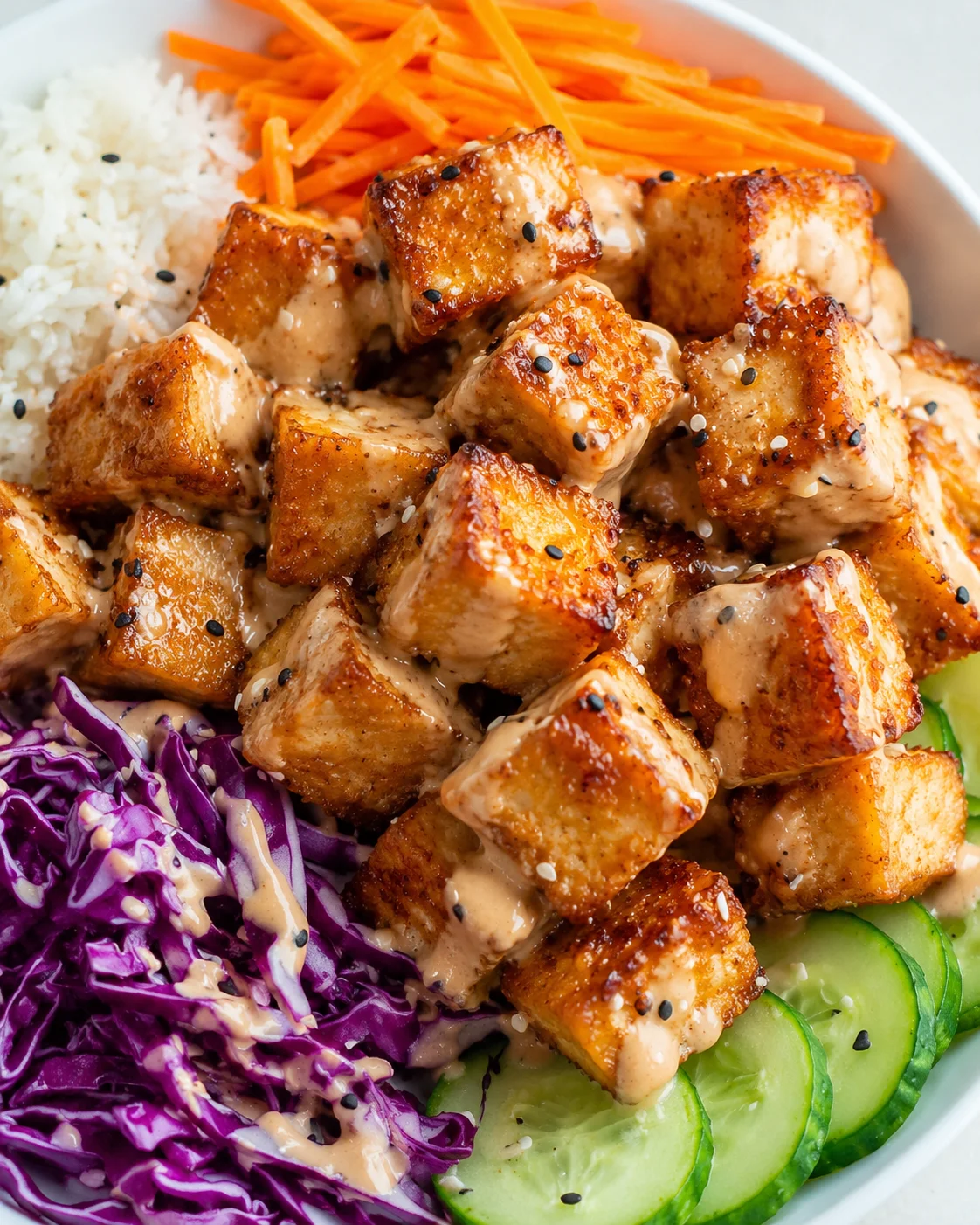 Crispy Bang Bang Tofu Recipe Delicious crispy tofu cubes coated in a creamy spicy sauce, served with vegetables