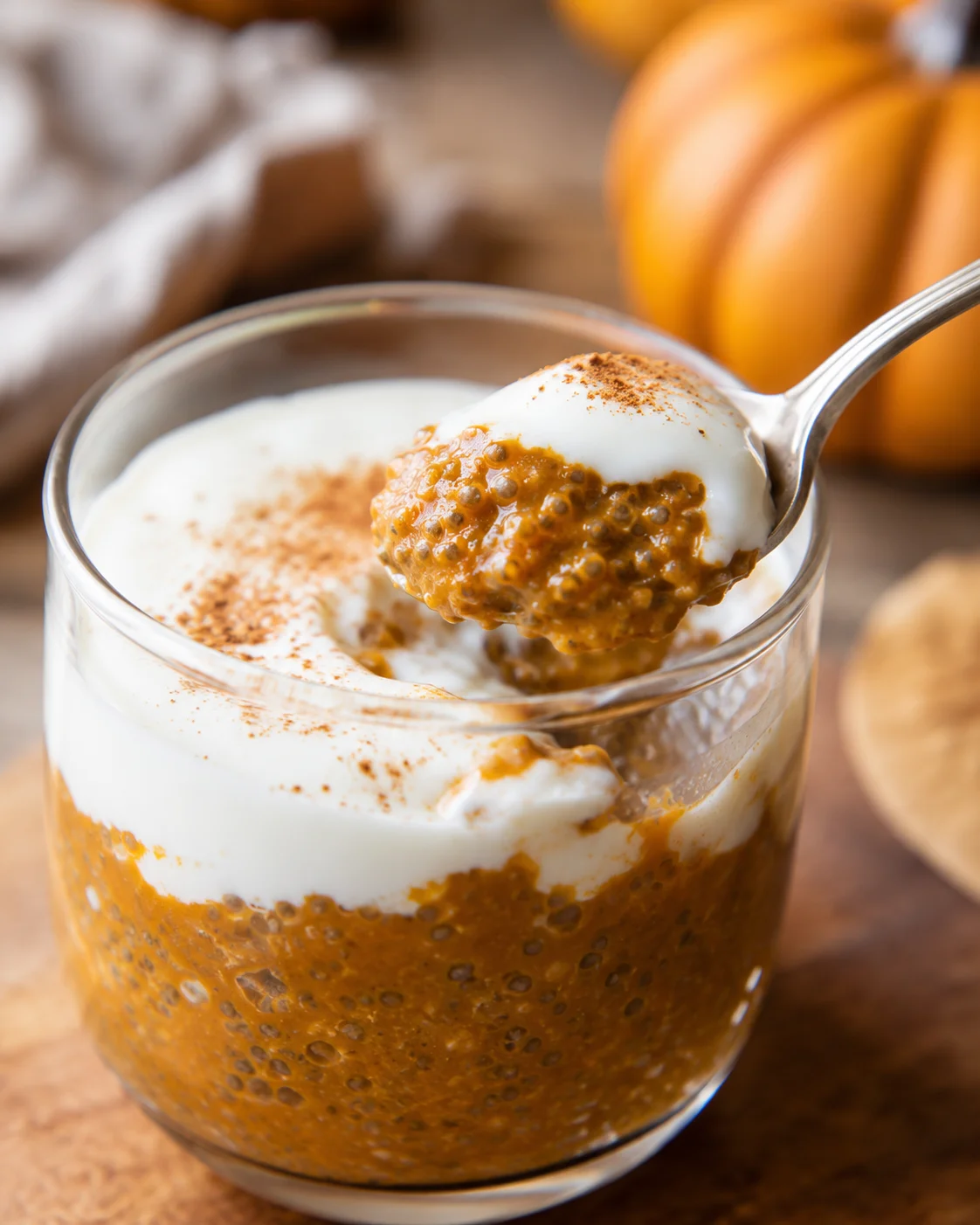 High Protein Pumpkin Chia Pudding Creamy pumpkin chia pudding topped with yogurt and cinnamon in a glass